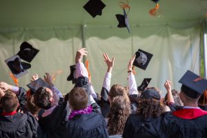 Students tossing their graduation caps.