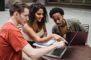 A group of three students study for an exam. 