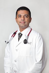 Dr. Amit Sapra standing with medical attire.